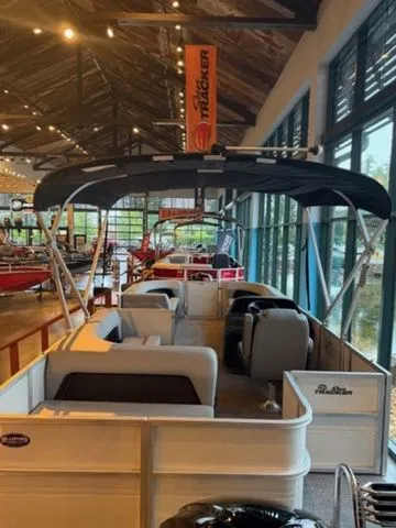 Slide: The Image of 2026 Sun Tracker PB 18 pontoon boat in showroom. - 10