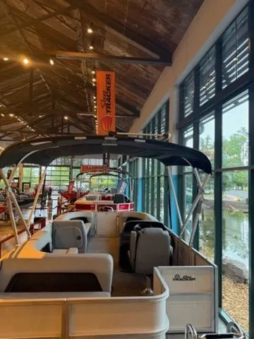 Slide: The Image of 2026 Sun Tracker PB 18 pontoon boat in showroom. - 3