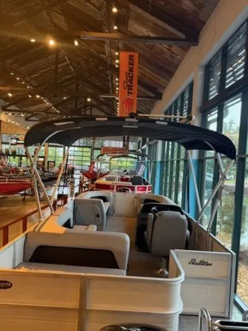 Slide: The Image of Sun Tracker PB 18 pontoon boat 2026 in a showroom. - 4