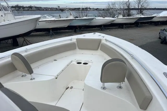 Slide: The Image of 2021 Key West 239 FS boat with spacious seating, docked near other boats by the water. - 11