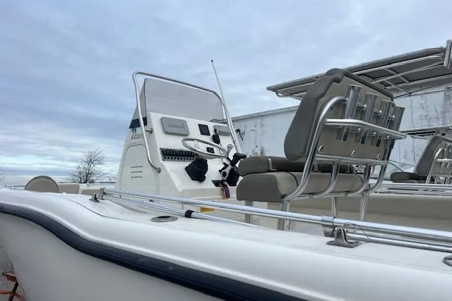Slide: The Image of 2021 Key West 239 FS boat with console and seating, under cloudy sky. - 3