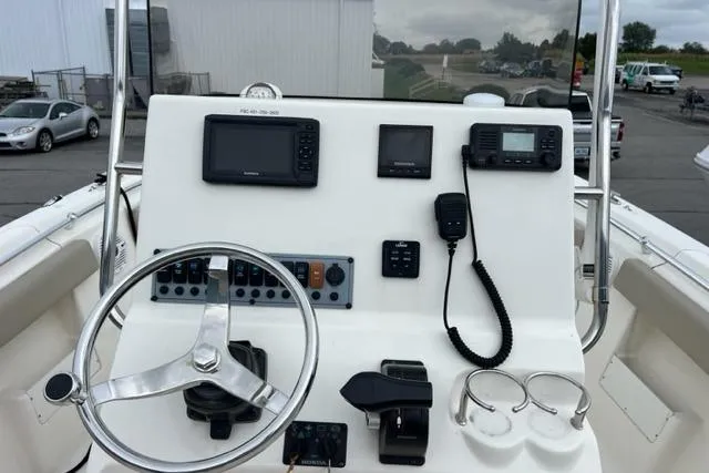 Slide: The Image of 2021 Key West 239 FS boat dashboard with steering wheel, navigation, and communication equipment. - 6