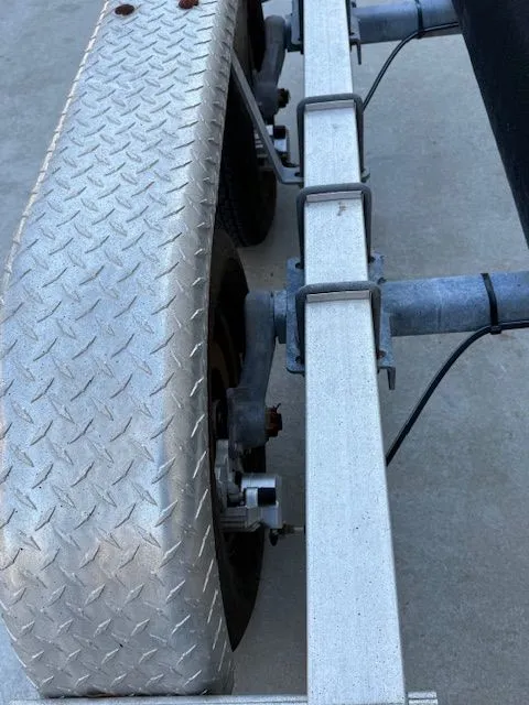 Slide: The Image of Close-up of a boat trailer with diamond plate wheel cover. - 18