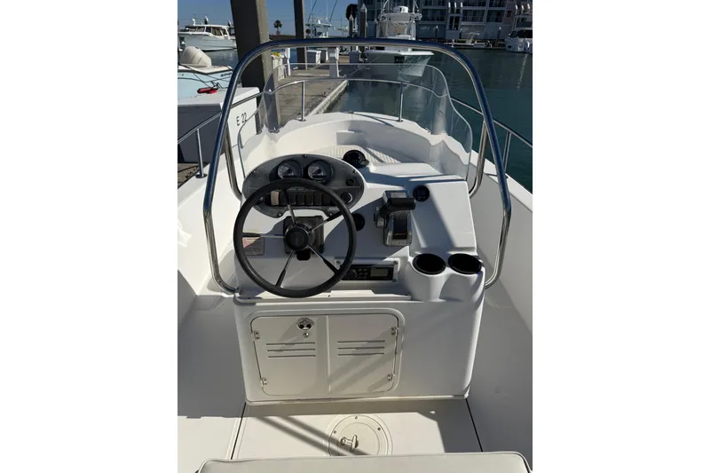 Slide: The Image of 2006 Boston Whaler 180 Dauntless boat console with steering wheel and controls. - 7