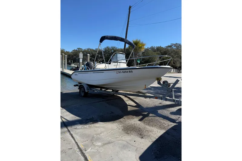 Slide: The Image of 2006 Boston Whaler 180 Dauntless boat on trailer at dockside. - 9