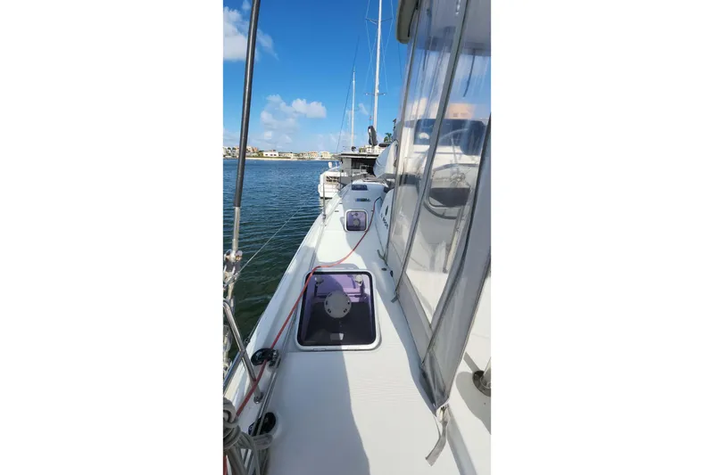 Slide: The Image of 2020 Lagoon 42 catamaran deck view with clear skies and calm waters. - 13