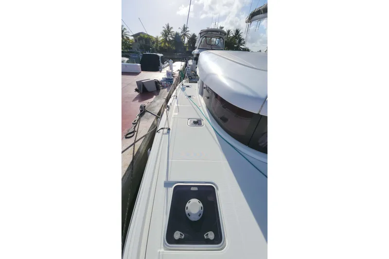 Slide: The Image of 2020 Lagoon 42 catamaran docked, showcasing sleek deck design and modern features. - 14