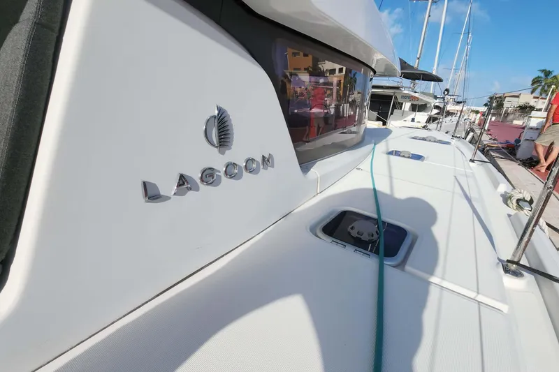 Slide: The Image of 2020 Lagoon 42 catamaran docked, showcasing sleek design and branding. - 20