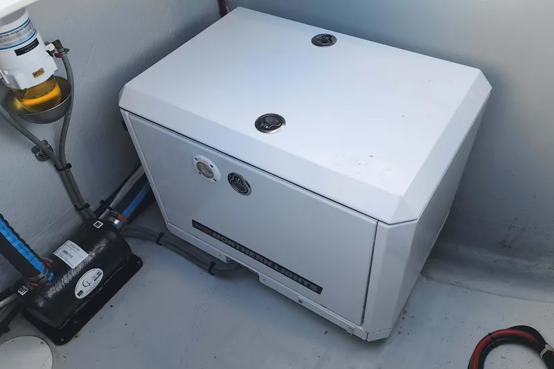Slide: The Image of Engine compartment of a 2020 Lagoon 42 catamaran with generator and fuel filter. - 25