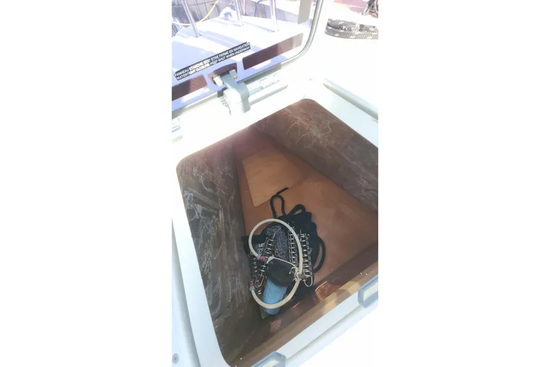 Slide: The Image of Open storage compartment on 2020 Lagoon 42 yacht with coiled rope inside. - 27