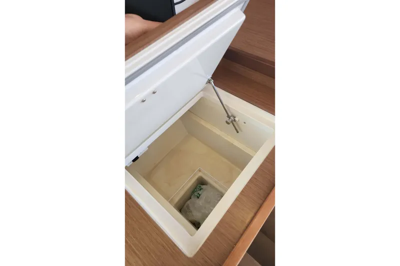 Slide: The Image of Open storage compartment on 2020 Lagoon 42 yacht, featuring a wooden finish. - 36