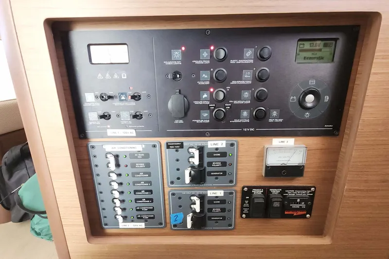 Slide: The Image of Control panel of a 2020 Lagoon 42 yacht, featuring various switches and gauges. - 39