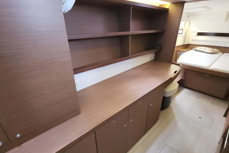 Slide: The Image of Interior of 2020 Lagoon 42 yacht with wooden cabinetry and cozy sleeping area. - 41