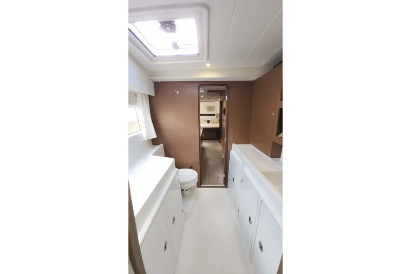 Slide: The Image of Interior of 2020 Lagoon 42 yacht bathroom with modern fixtures and skylight. - 45