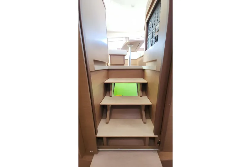 Slide: The Image of Interior stairs of 2020 Lagoon 42 catamaran, featuring wooden steps and modern design. - 48