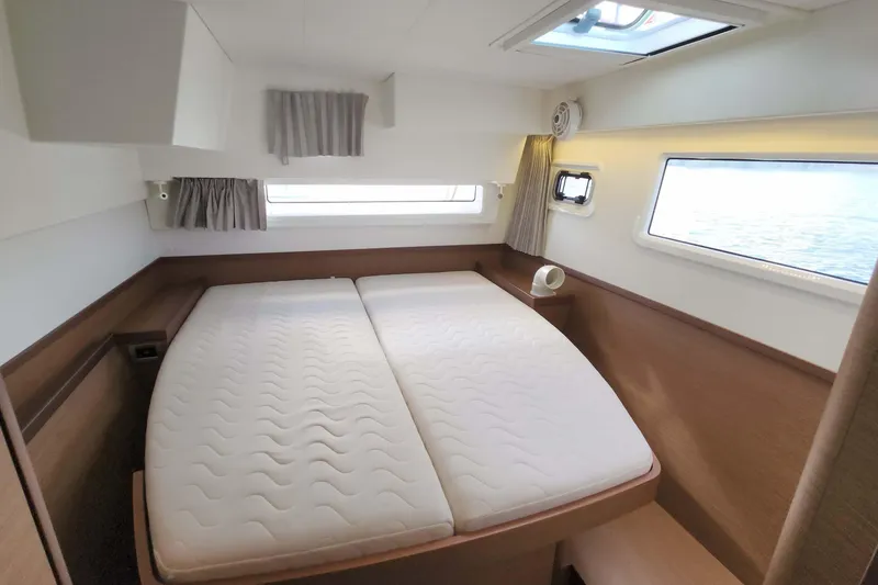Slide: The Image of Luxurious cabin interior of 2020 Lagoon 42 catamaran with comfortable bedding and scenic windows. - 54