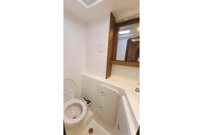 Slide: The Image of Bathroom interior of 2020 Lagoon 42 catamaran with toilet and mirror. - 58