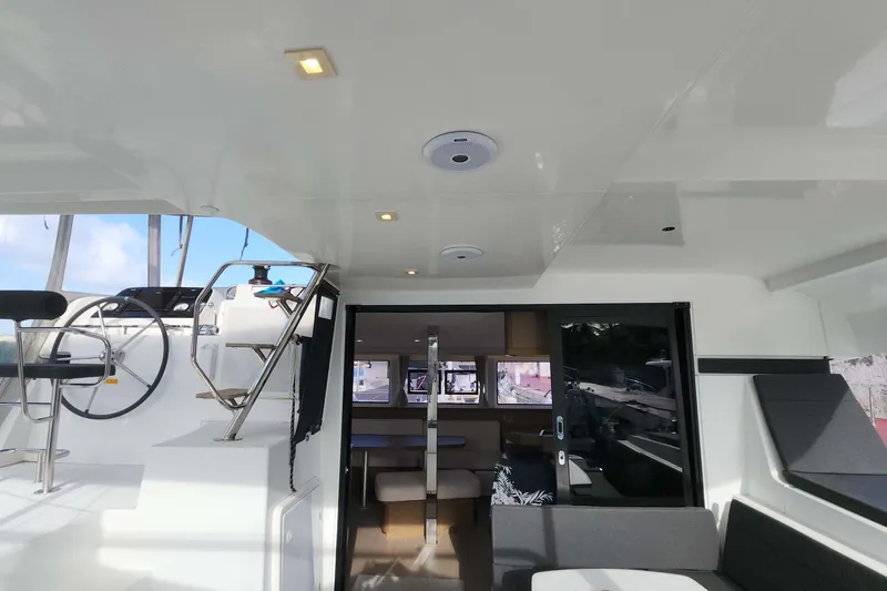Slide: The Image of Interior view of 2020 Lagoon 42 catamaran, featuring helm station and seating area. - 6