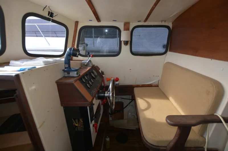 Slide: The Image of 1974 Fales Navigator boat interior with steering wheel and control panel. - 12