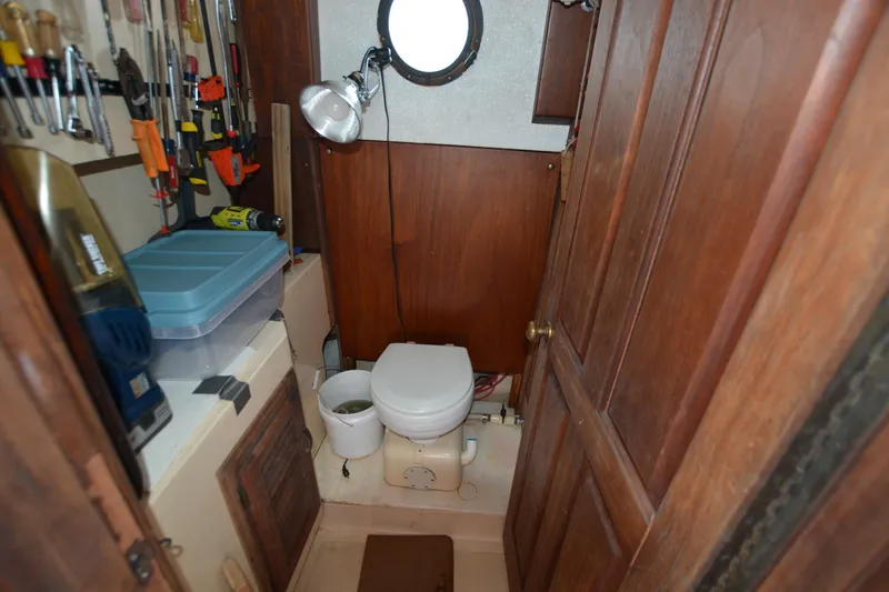 Slide: The Image of 1974 Fales Navigator boat bathroom with tools and wooden cabinetry. - 18