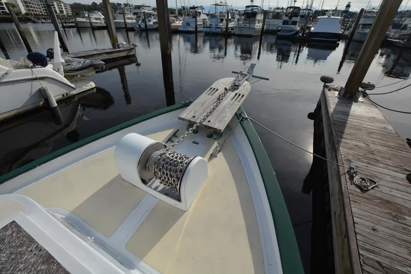 Slide: The Image of 1974 Fales Navigator boat docked at marina with anchor chain visible. - 5