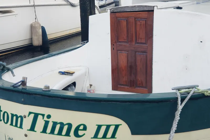 Slide: The Image of 1974 Fales Navigator boat with wooden door and visible deck details. - 9