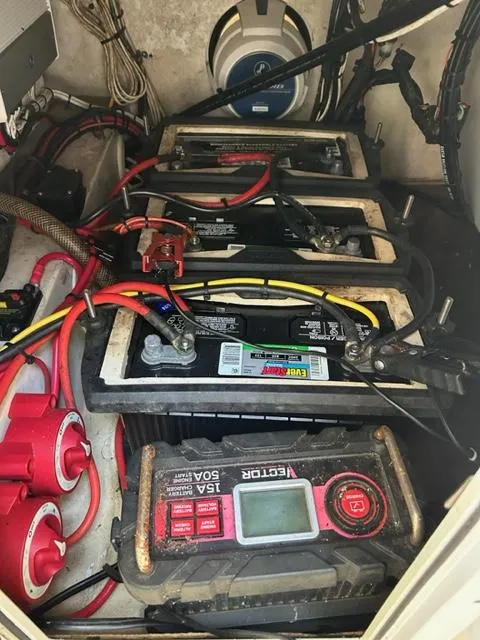 Slide: The Image of Battery compartment of a 2000 Regulator 23' Center Console boat with wiring and tester. - 11