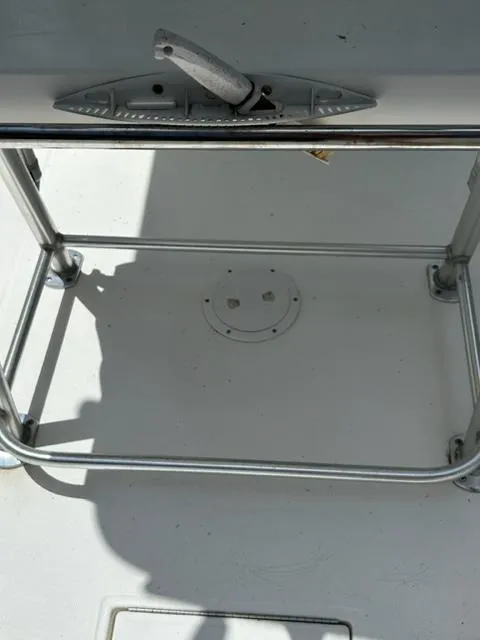 Slide: The Image of 2000 Regulator 23' Center Console boat deck with metal railing and handle. - 12