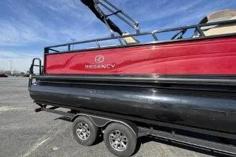 Slide: The Image of 2025 Regency 250 DL3 pontoon boat on trailer, red and black design. - 6