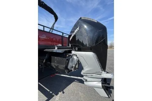 Slide: The Image of 2025 Regency 250 DL3 boat with powerful Mercury outboard motor, parked on pavement. - 9