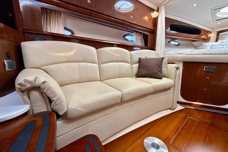 Slide: The Image of Luxurious interior of 2016 Four Winns V335 yacht with beige leather sofa and wooden accents. - 19