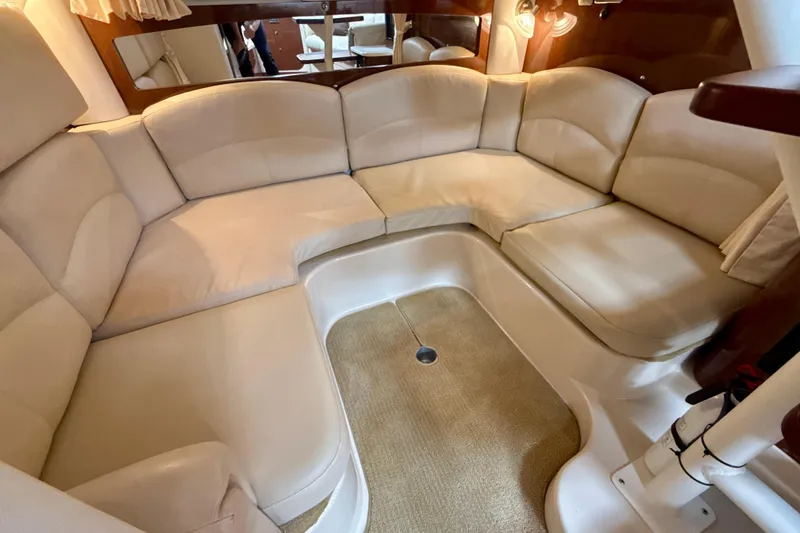Slide: The Image of Luxurious interior seating of 2016 Four Winns V335 boat with beige upholstery. - 23