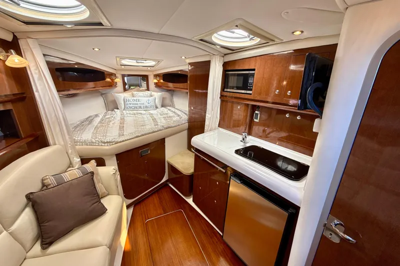 Slide: The Image of Luxurious interior of 2016 Four Winns V335 yacht with cozy bed and modern kitchenette. - 26