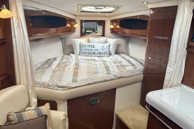 Slide: The Image of Luxurious 2016 Four Winns V335 cabin interior with cozy bed and nautical decor. - 27