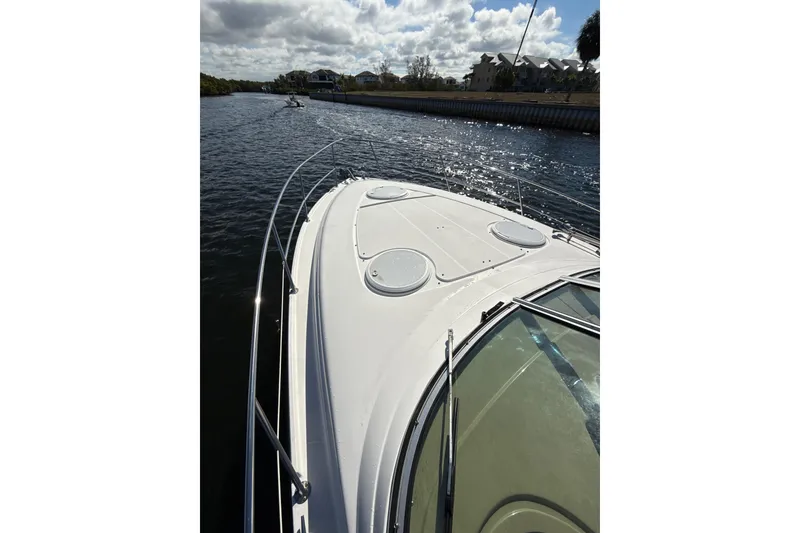 Slide: The Image of 2016 Four Winns V335 boat cruising on a sunny waterway. - 28