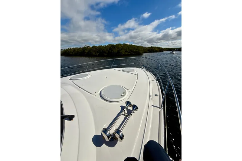 Slide: The Image of 2016 Four Winns V335 boat cruising on a sunny day with scenic water view. - 29