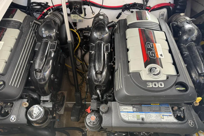 Slide: The Image of Engine compartment of a 2016 Four Winns V335 boat, featuring dual 300 horsepower engines. - 33
