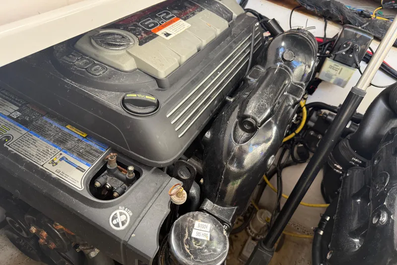 Slide: The Image of Engine compartment of a 2016 Four Winns V335 boat, featuring a 6.2-liter engine. - 35
