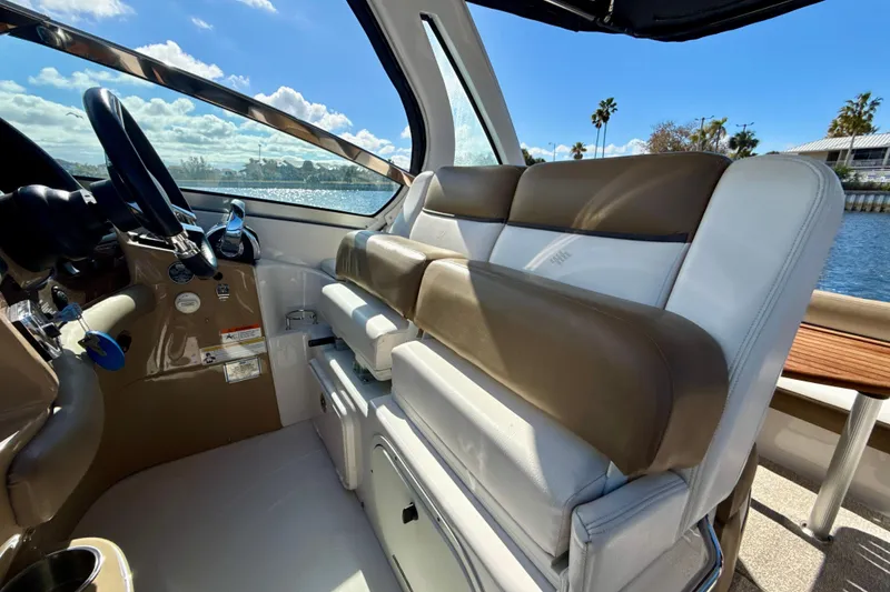Slide: The Image of Interior of 2016 Four Winns V335 boat with leather seating and steering wheel. - 7