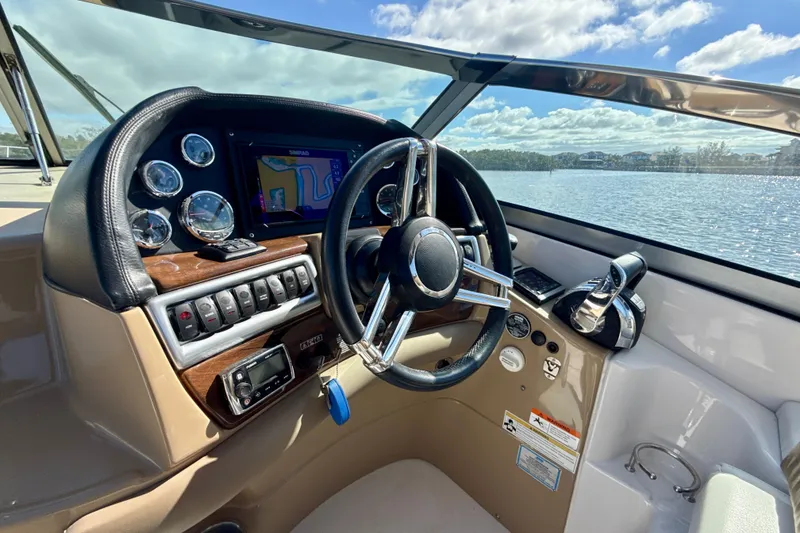 Slide: The Image of 2016 Four Winns V335 boat dashboard with steering wheel and navigation system. - 8