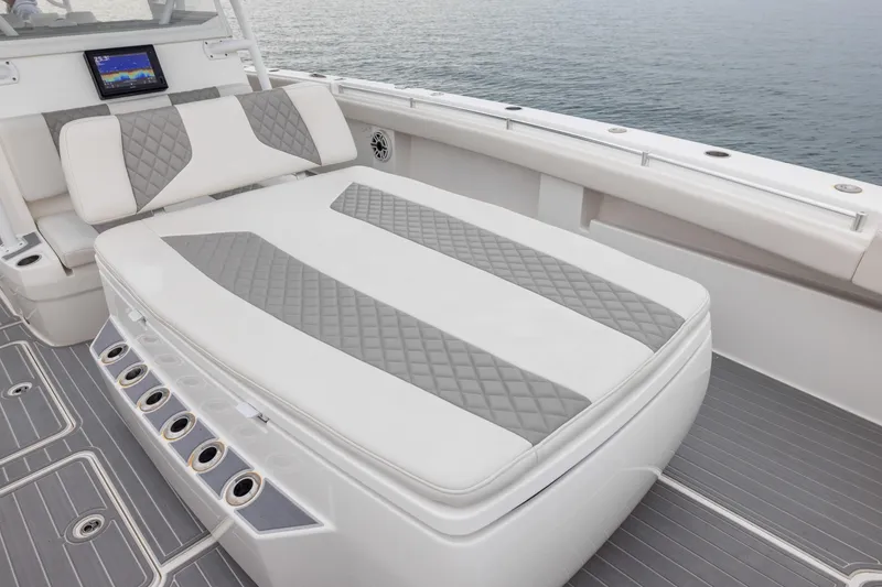 Slide: The Image of Luxurious seating on 2020 Invincible 40 Catamaran with quilted design, ocean backdrop. - 10