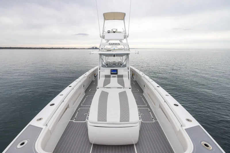 Slide: The Image of 2020 Invincible 40 Catamaran on calm water, showcasing spacious deck and modern design. - 12