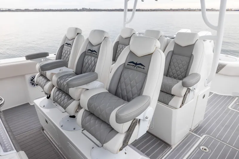 Slide: The Image of Luxurious seating on 2020 Invincible 40 Catamaran, featuring quilted gray and white upholstery. - 14