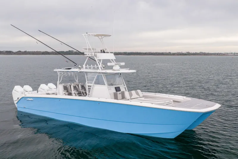 Slide: The Image of 2020 Invincible 40 Catamaran in blue on calm waters, showcasing sleek design. - 2