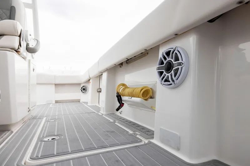 Slide: The Image of 2020 Invincible 40 Catamaran interior with speakers and coiled hose on deck. - 23