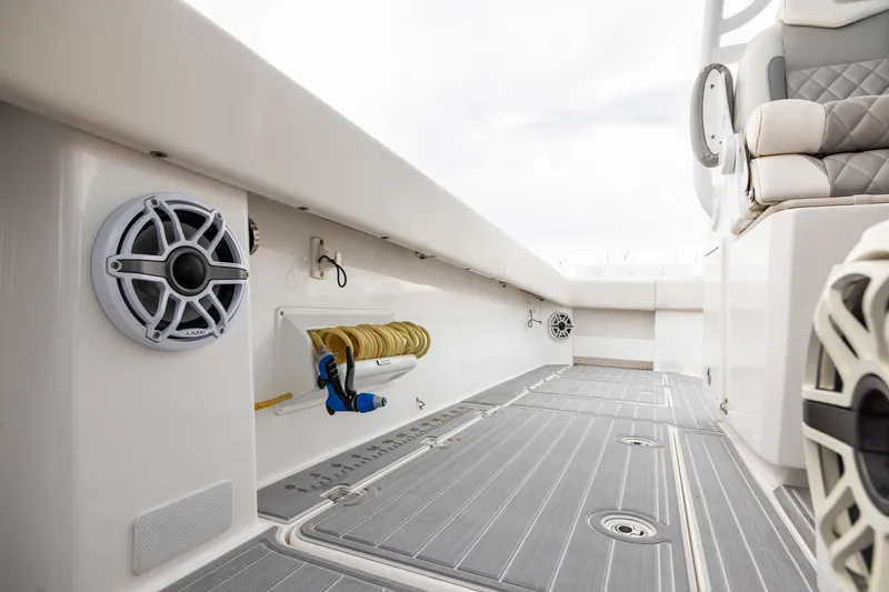 Slide: The Image of 2020 Invincible 40 Catamaran interior with speakers, hose, and cushioned seating. - 25