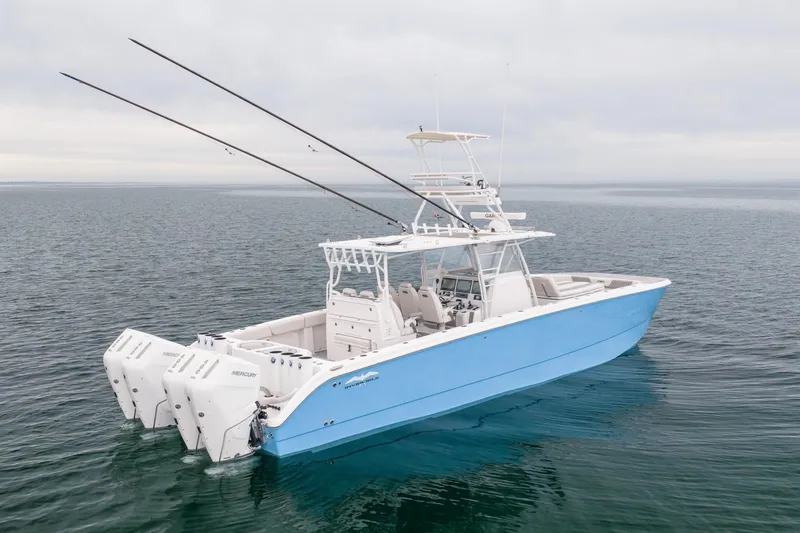 Slide: The Image of 2020 Invincible 40 Catamaran in blue, equipped with multiple outboard engines, cruising on open water. - 3