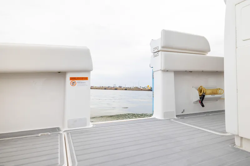 Slide: The Image of 2020 Invincible 40 Catamaran deck view with seating and water hose storage. - 30