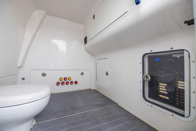 Slide: The Image of 2020 Invincible 40 Catamaran interior with control panel and marine toilet. - 34