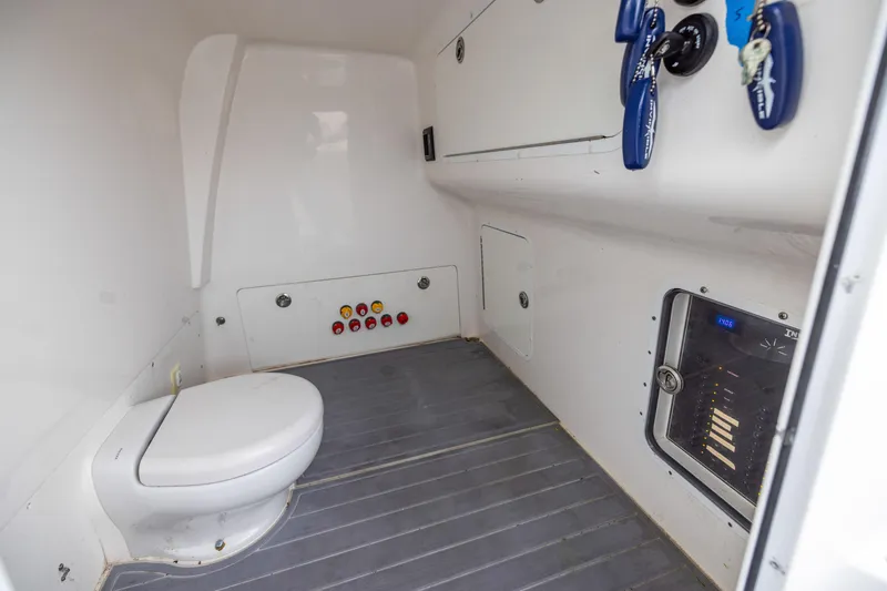 Slide: The Image of Interior of 2020 Invincible 40 Catamaran featuring a compact marine toilet and control panel. - 35